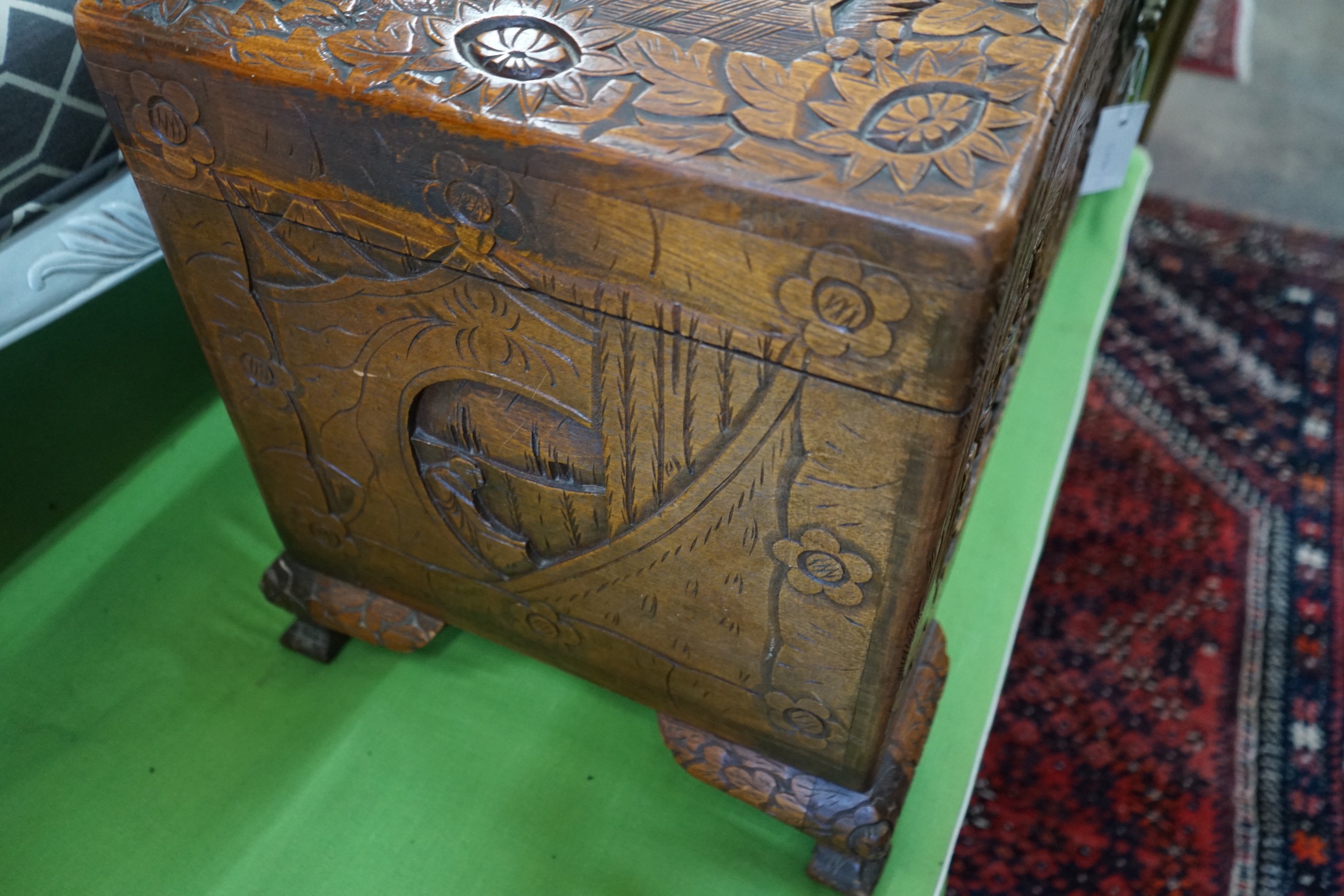 A Chinese carved camphorwood coffer with domed cover, length 93cm, depth 43cm, height 55cm